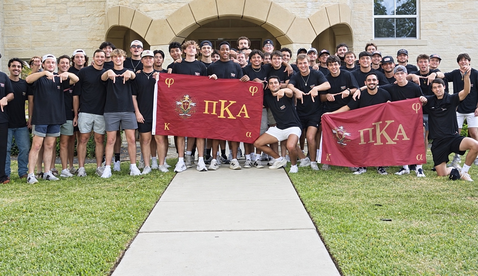 The Alpha Omicron chapter gathered outside the PIKE house